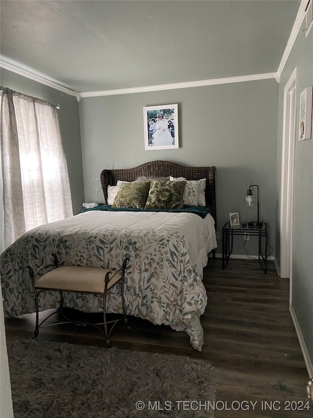 bedroom featuring dark hardwood / wood-style floors and crown molding