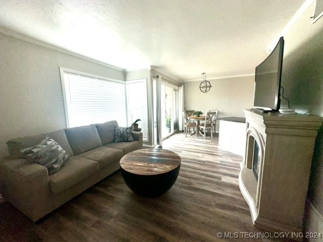 living room with hardwood / wood-style flooring and crown molding