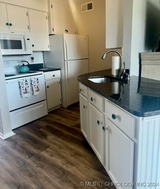 kitchen featuring white cabinetry, sink, dark wood-type flooring, white appliances, and dark stone countertops