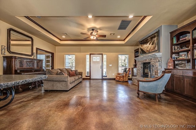 living room with ceiling fan and a raised ceiling