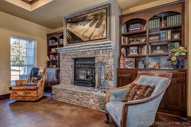 sitting room featuring a wood stove