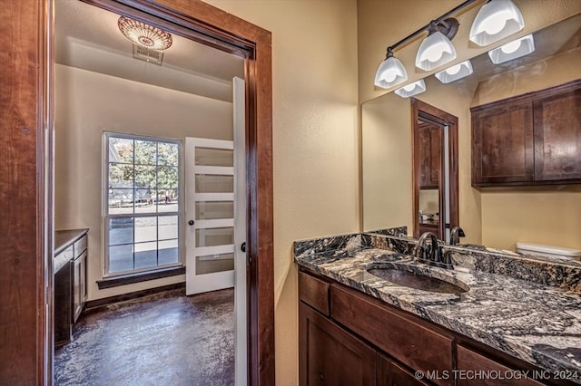 bathroom featuring vanity, a textured ceiling, toilet, and concrete floors