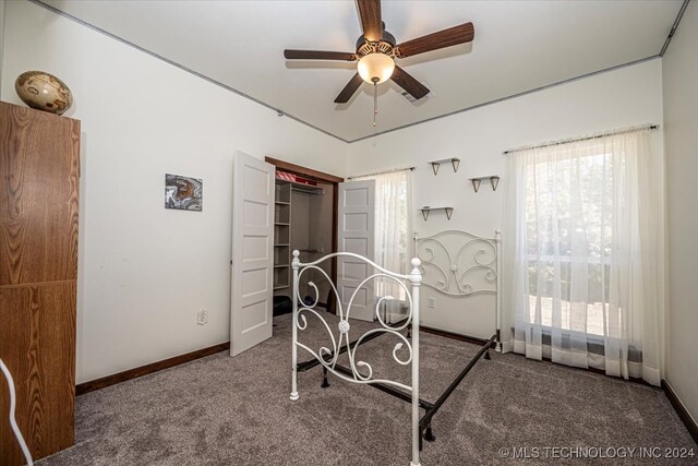 bedroom with a closet, ceiling fan, and carpet flooring