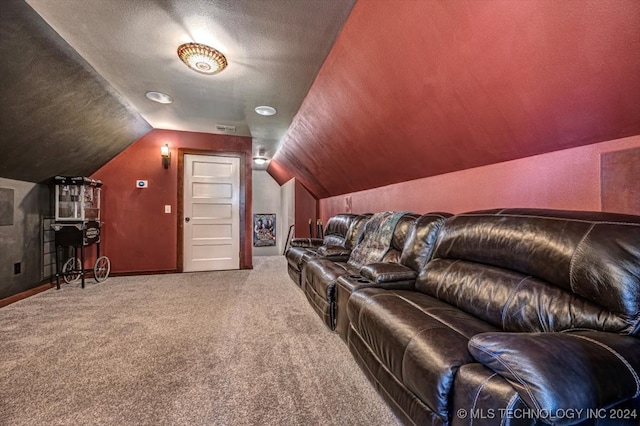 carpeted home theater featuring lofted ceiling and a textured ceiling