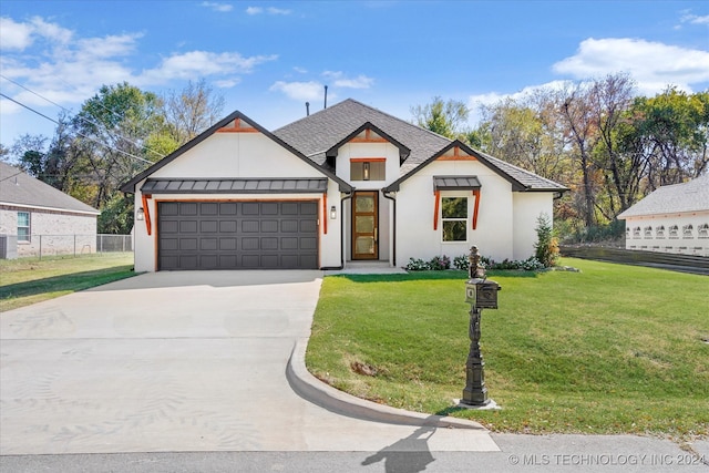 view of front of home with a front yard, central AC, and a garage