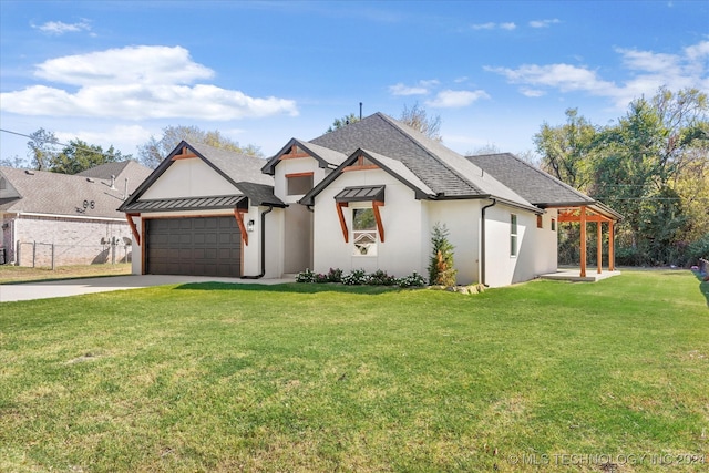 view of front of home featuring a front yard and a garage