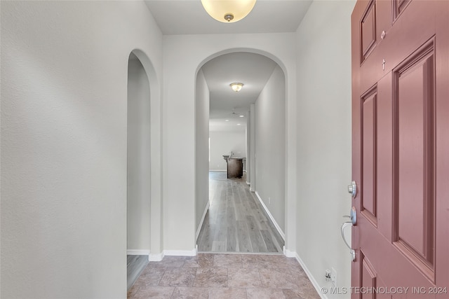 hallway with light hardwood / wood-style flooring