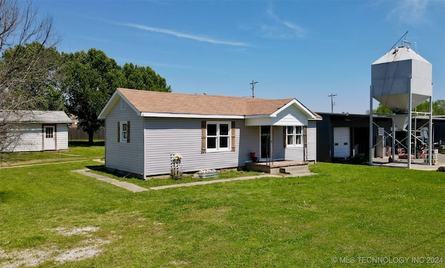 rear view of house featuring a lawn