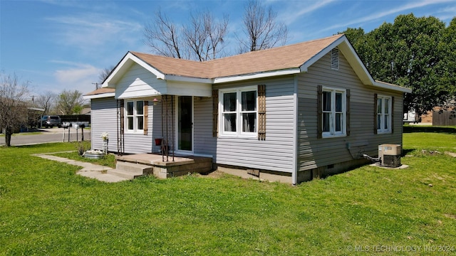 view of front facade featuring central air condition unit and a front lawn