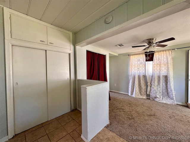 kitchen featuring light carpet and ceiling fan