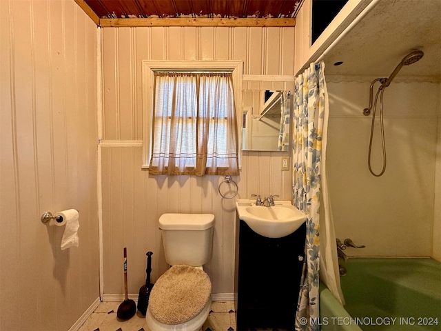 full bathroom with vanity, toilet, wood walls, and shower / bathtub combination with curtain