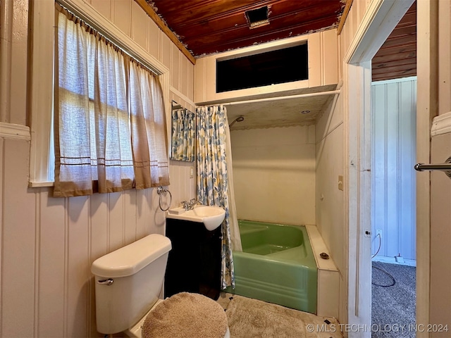 bathroom featuring a bathing tub, wood ceiling, toilet, wood walls, and vanity