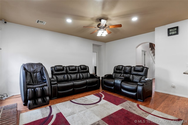 home theater with wood-type flooring and ceiling fan