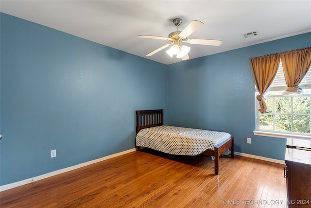 bedroom featuring light hardwood / wood-style floors and ceiling fan