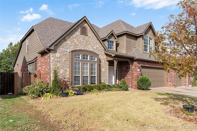 view of front of home with a front lawn and a garage