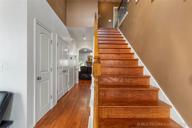 stairway featuring wood-type flooring