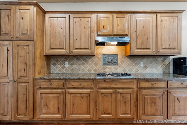 kitchen featuring stone counters, stainless steel gas cooktop, and tasteful backsplash