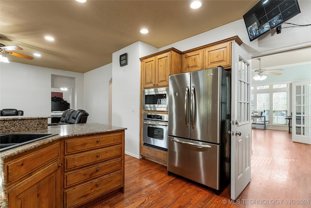 kitchen featuring decorative backsplash, stone countertops, french doors, stainless steel appliances, and dark hardwood / wood-style flooring