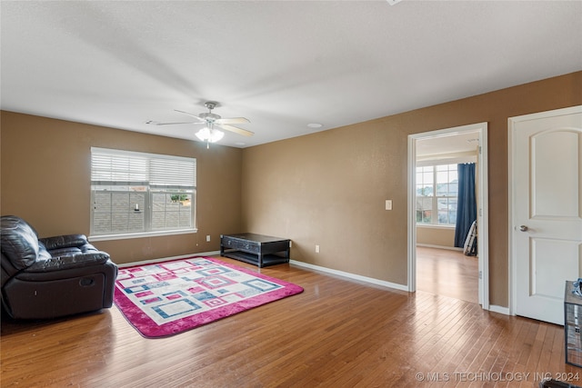 sitting room featuring hardwood / wood-style flooring, ceiling fan, and a wealth of natural light