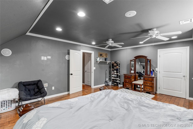 bedroom featuring ceiling fan, ornamental molding, lofted ceiling, and hardwood / wood-style floors