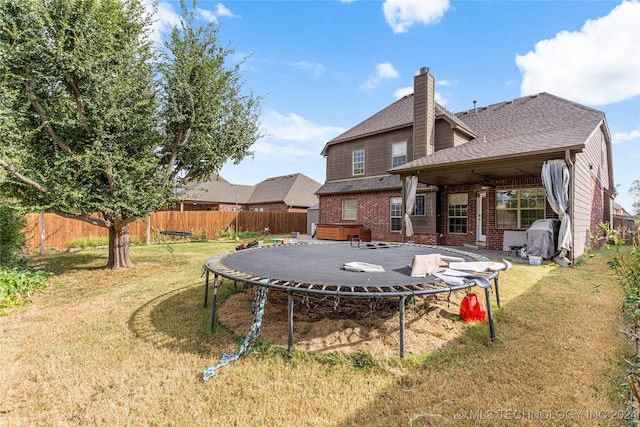 rear view of house featuring a yard and a patio area