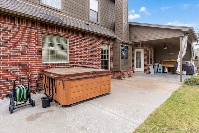 view of patio / terrace with a hot tub