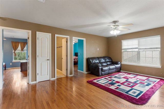 living room featuring wood-type flooring and ceiling fan