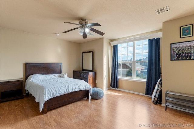 bedroom with ceiling fan and light hardwood / wood-style flooring