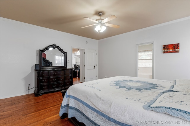 bedroom featuring crown molding, dark wood-type flooring, connected bathroom, and ceiling fan