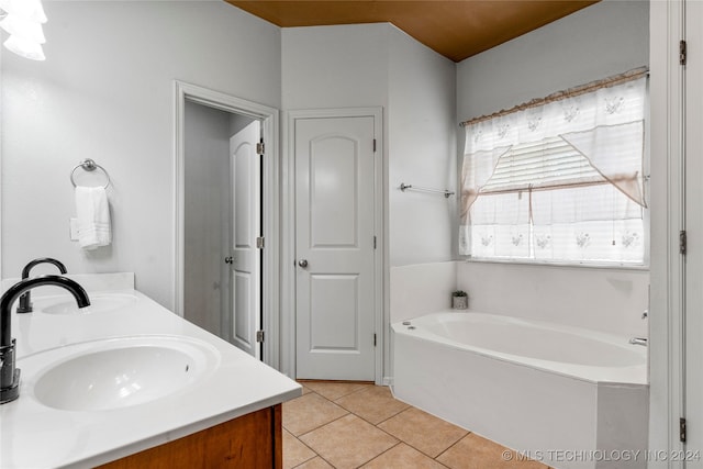 bathroom featuring vanity, a tub, and tile patterned floors