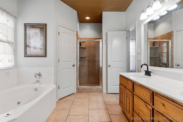 bathroom featuring vanity, independent shower and bath, and tile patterned floors