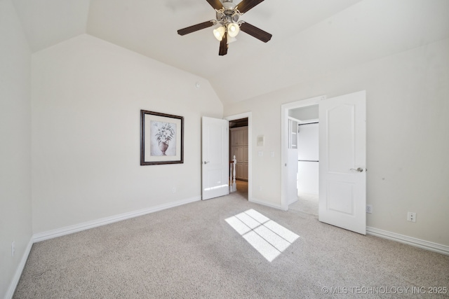 unfurnished bedroom with ceiling fan, light colored carpet, and vaulted ceiling