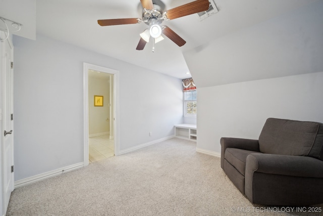 sitting room with lofted ceiling, light colored carpet, and ceiling fan