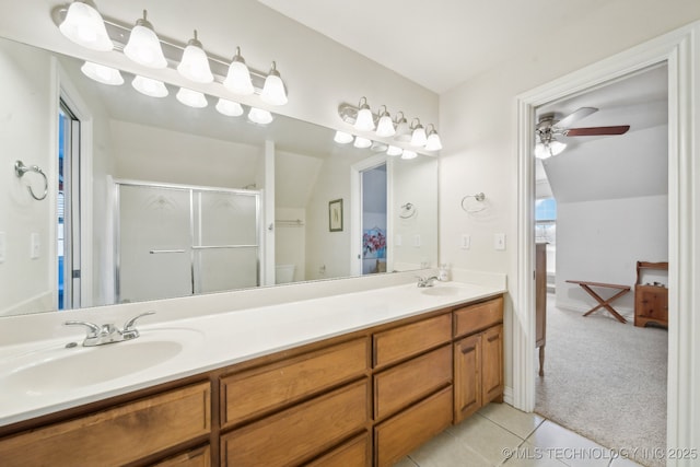 bathroom featuring a shower with door, tile patterned flooring, vanity, vaulted ceiling, and toilet