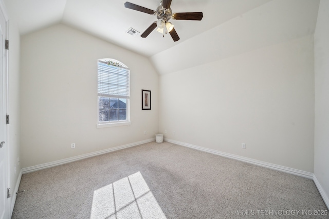 carpeted empty room with ceiling fan and lofted ceiling