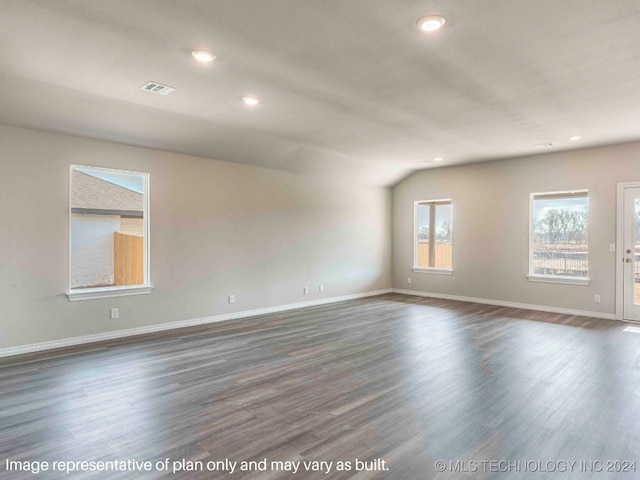 unfurnished room with dark wood-type flooring and lofted ceiling