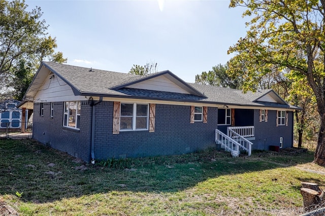 rear view of property featuring a lawn