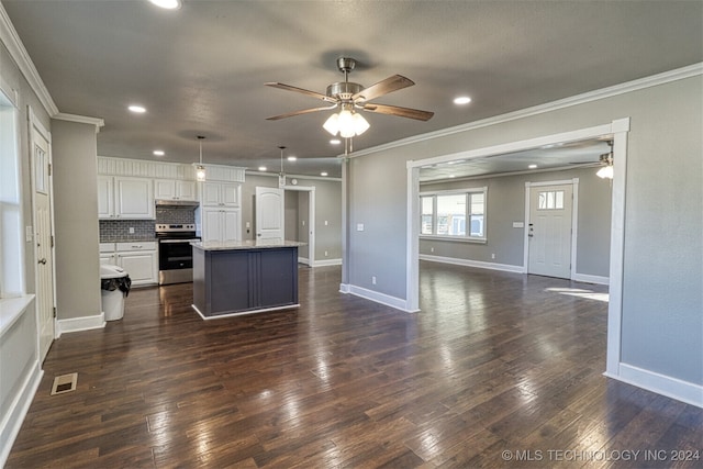 kitchen featuring a center island, stainless steel electric stove, pendant lighting, white cabinets, and dark wood-type flooring