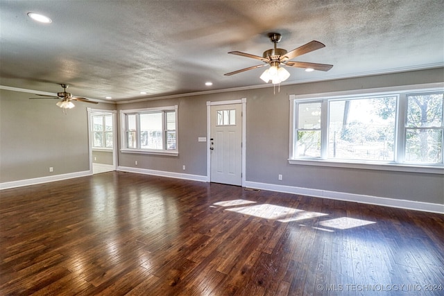 unfurnished living room featuring crown molding, a textured ceiling, dark hardwood / wood-style floors, and ceiling fan