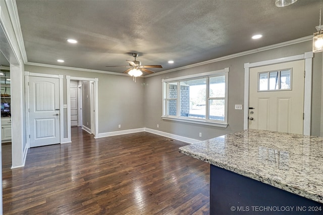 interior space featuring crown molding, ceiling fan, a textured ceiling, and dark hardwood / wood-style flooring