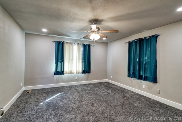 spare room featuring ceiling fan, carpet, and a textured ceiling