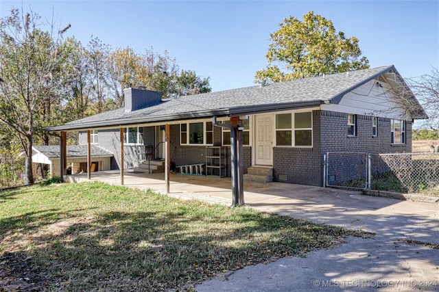 view of front facade with a patio and a front lawn