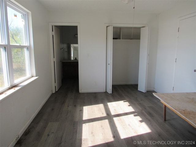 unfurnished bedroom featuring dark hardwood / wood-style floors