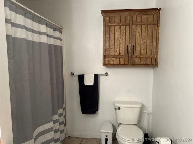 bathroom with toilet and tile patterned floors