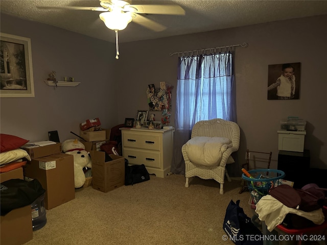 bedroom with carpet floors, a textured ceiling, and ceiling fan