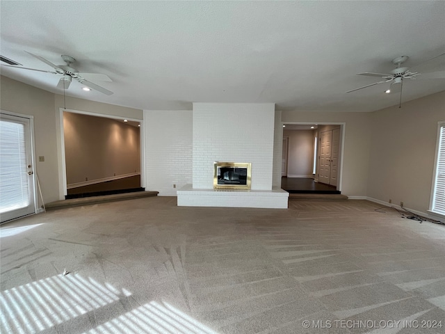 unfurnished living room featuring light carpet and ceiling fan