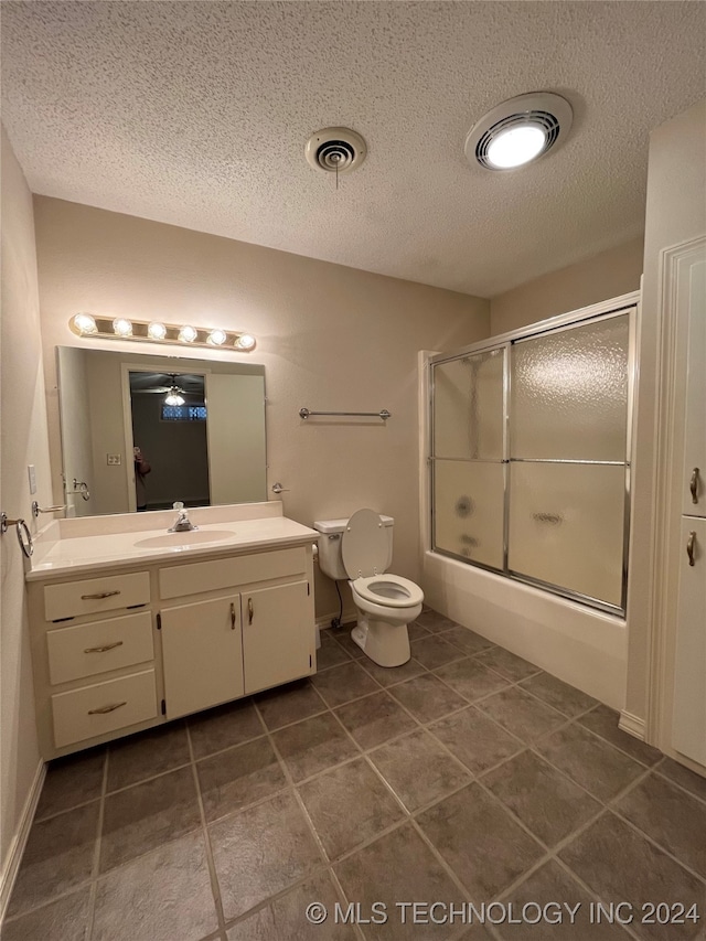 full bathroom with vanity, ceiling fan, combined bath / shower with glass door, and a textured ceiling