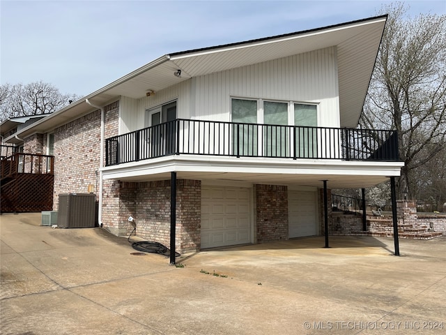 view of property exterior featuring central AC and a garage