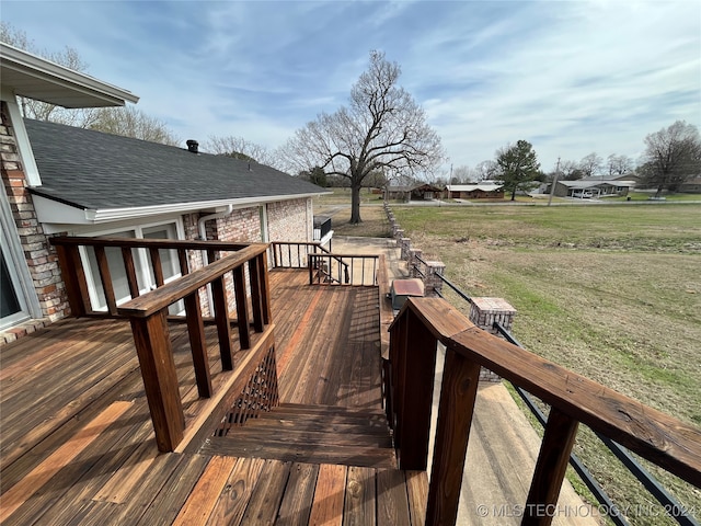 wooden terrace featuring a yard