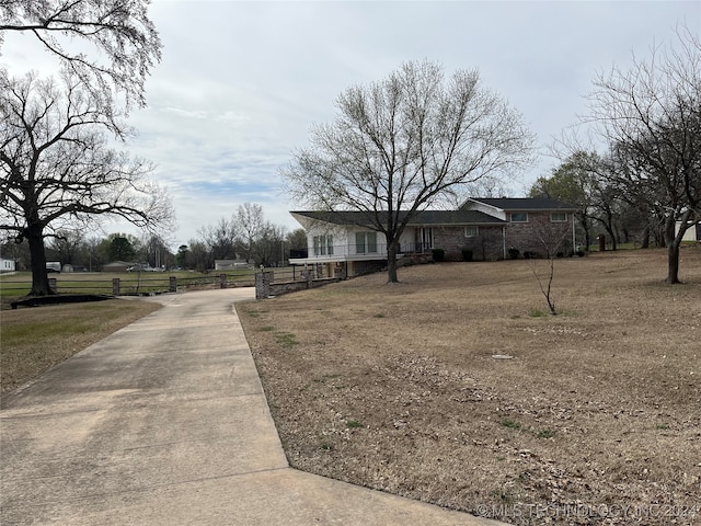 view of front of home with a porch and a front lawn